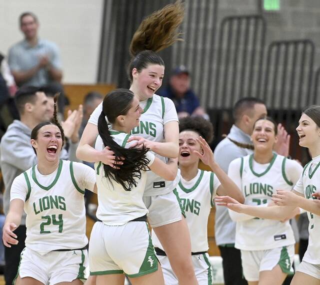 South Fayettes Juliette Leroux is mobbed by teammates after scoring her 1,00th career point during the Lions game against Norwin on Jan. 10 at South Fayette. (Christopher Horner | TribLive)