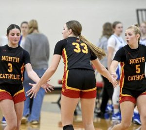 North Catholics Lauren Reitz celebrates with Finley OShea and Brady Wehner after defeating Berlin Brothersvalley on Dec. 30, 2025, at the Trojanettes holiday tournament in Cranberry. (Christopher Horner | TribLive)