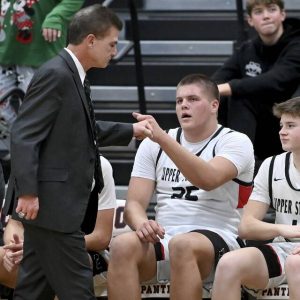 Upper St. Clair’s Ryan Robbins fist bumps head coach Danny Holzer during the fourth quarter against Norwin on Tuesday, Dec. 9, 2025, at USC. (Christopher Horner | TribLive)
