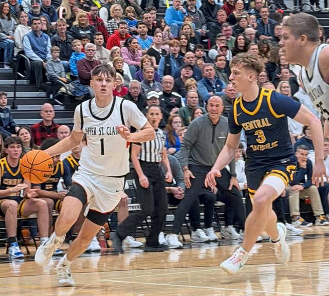 Upper St. Clairs Luke Marchinsky drives as Central Catholics Enzo Khalil defends on Friday, Jan. 16, 2026. (Antonio Rossetti | For TribLive)