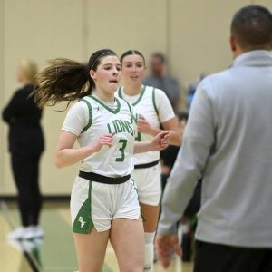 South Fayettes Haylie Lamonde is greeted by coach Bryan Bennett as she exits the game with Ryan Oldaker during the second half against Montour on Dec. 18, 2025. (Christopher Horner | TribLive)