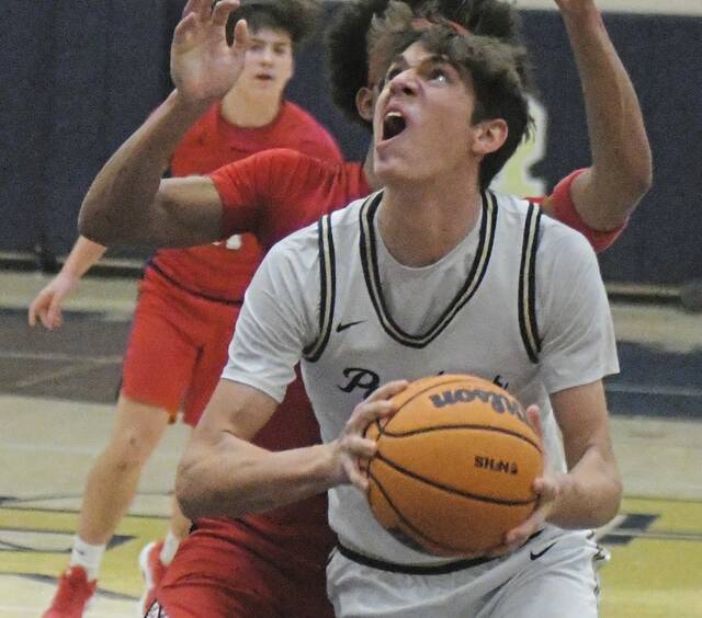 Franklin Regionals Colin Holt goes up for a basket against McKeesport on Tuesday. (Paul Schofield | TribLive)
