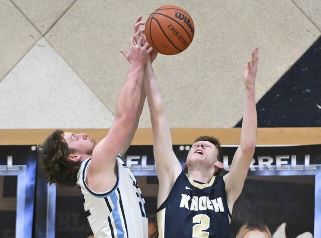 Knochs Derek Lang fights for a rebound with Burrells Trey Coury on Tuesday at Burrell High School. (Chaz Palla | TribLive)