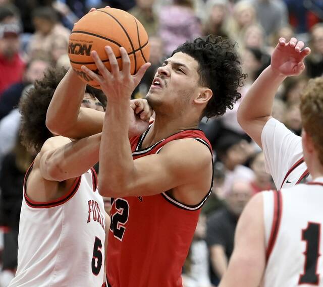 New Castles Kai Cox drives Fox Chapels John Rehak on Jan. 9 at Fox Chapel. (Christopher Horner | TribLive)