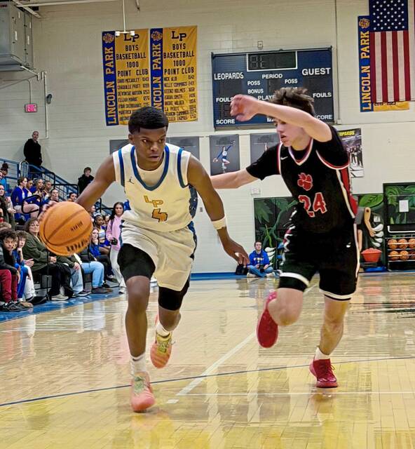 Lincoln Park's Josh Pratt drives as Moon's Caden Kopay defends Tuesday, Jan. 20, 2026. (Antonio Rossetti | For TribLive)