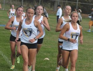 The Norwin girls cross country teams (from left) Addison Farrah, Anna Dansak, Jillan Ryba, Emily Dansak and Annie Czajkowski run together during the Westmoreland County Coaches Association meet Oct. 8, 2025. Norwin placed first. (Paul Schofield | TribLive)