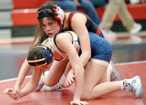 Fox Chapel freshman Ariana Morris plams her next move after earning a reversal in the first period of her 100-pound match Jan. 21 at Fox Chapel. Morris pinned Kiski Areas Kamdyn Pitts in the second period. (Josh Rizzo | For TribLive)