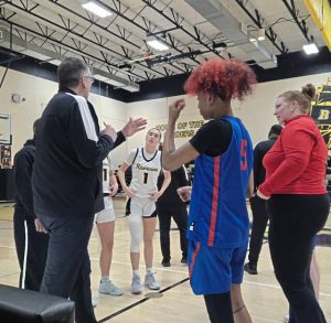 Riverview (left) and Jeannette players and coaches meet for a pregame talk Thursday night in Oakmont. (Bill Beckner Jr. | TribLive)