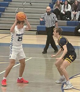 Hempfield's Brody Graft (25) looks to pass the ball over the defense of Central Catholic's Ryan Hower on Friday, Jan. 23, 2026, at Hempfield. (Dave Mackall | For TribLive)
