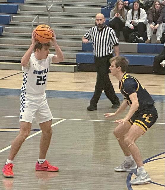 Hempfield's Brody Graft (25) looks to pass the ball over the defense of Central Catholic's Ryan Hower on Friday, Jan. 23, 2026, at Hempfield. (Dave Mackall | For TribLive)
