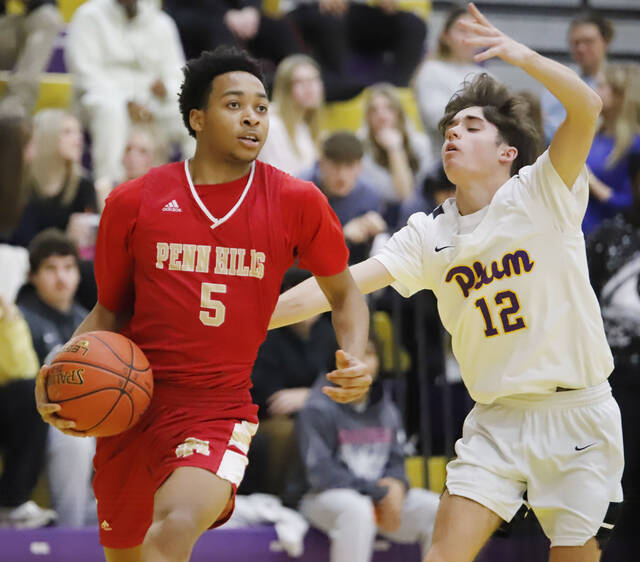 Penn Hills Amon Hawthorne attacks the rim while being guarded by Plums Jesse Stead on Jan. 6. (Josh Rizzo | For TribLive)