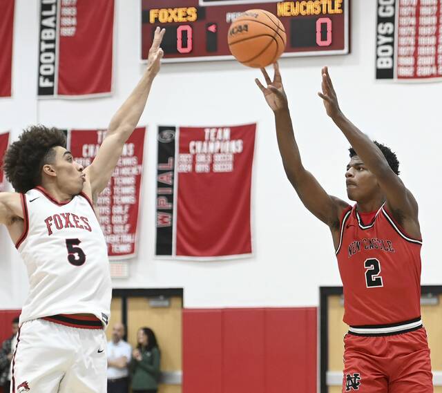 New Castles Damian Harrison shoots a 3-pointer over Fox Chapels John Rehak on Jan. 9 at Fox Chapel. (Christopher Horner | TribLive)