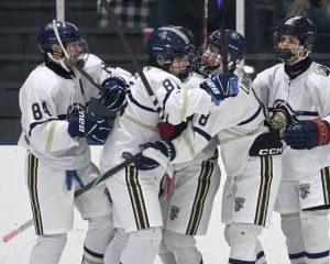 Knoch’s Drew Ross (81) celebrates with Brady Linamen after scoring against Burrell on Monday, Dec. 15, 2025, at Frozen Pond. (Christopher Horner | TribLive)