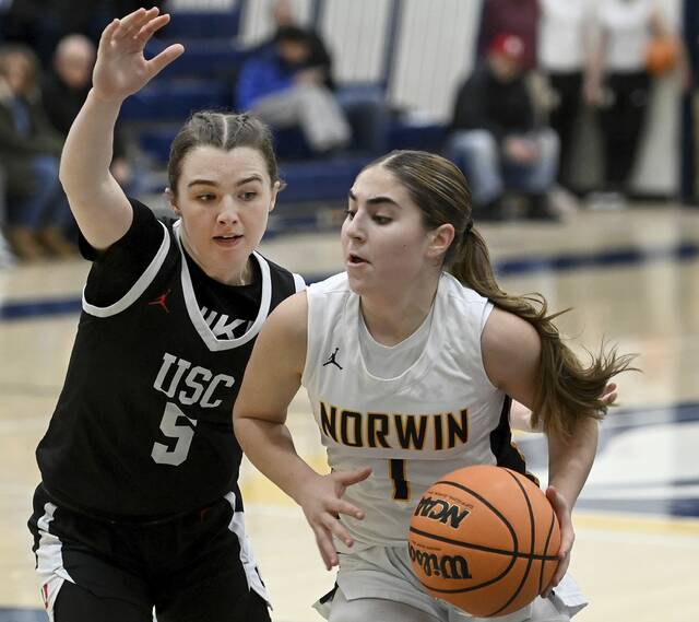 Norwins Giuliana Giannikas drives past Upper St. Clairs Ryan Prunzik on Tuesday. (Christopher Horner | TribLive)