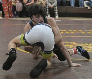Franklin Regional junior Sal Nassif takes down Norwins Cash Mitchell at 127 pounds at the Westmoreland County Coaches Association tournament Jan. 9. (Paul Schofield | TribLive).