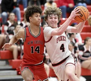 Fox Chapels Jackson Helgert drives to the basket against New Castles Qualin Davis on Jan. 9 at Fox Chapel. (Christopher Horner | TribLive)