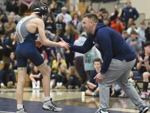 Franklin Regional head coach Matt Lebe celebrates with Salvatore Colangelo after beating Norwins Luca Butera 2-1 during the 107-pound bout Jan. 20, 2026 at Franklin Regional High School. (Chaz Palla | TribLive)