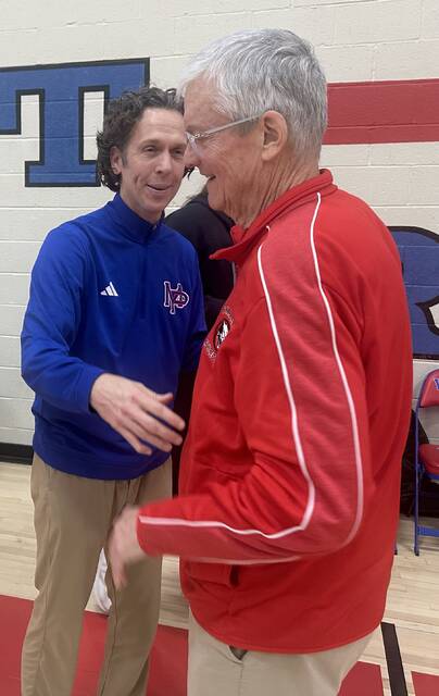 Mt. Pleasant coach Mark Katarski (left) congratulates Charleroi coach Joe Dunn, a former Mt. Pleasant coach, after Charlerois victory Friday in Mt. Pleasant Township. (Dave Mackall | For TribLive)