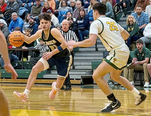Knochs Teegan Finucan drives against Deer Lakes Dylan Ferraro on Friday. (Antonio Rossetti | For TribLive)