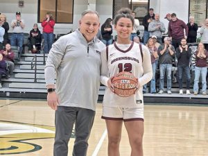 Greensburg Central Catholic girls basketball coach Chris Skatell (left) poses with senior guard Jayla Peterson after she scored her 1,000th career point Saturday night at the Shootout at Saint Vincent in Latrobe. (Bill Beckner Jr. | TribLive)