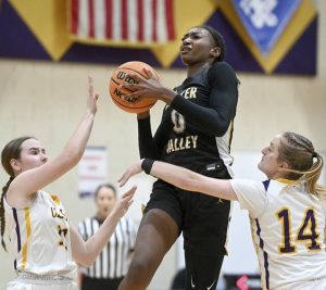Quaker Valley’s Mimi Thiero drives between OLSH’s Sara Daeschner and Leah Parker during their game on Thursday, Jan. 22, 2026, in Coraopolis. (Christopher Horner | TribLive)