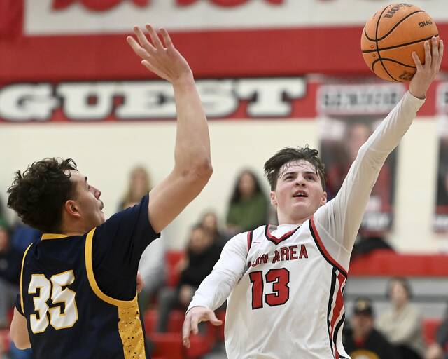 Moon’s Brody Bauman scores past Mars’ Ben Detisch during their game on Friday, Jan. 30, 2026, at Moon. (Christopher Horner | TribLive)