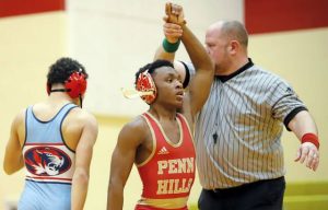 Penn Hills senior wrestler Daemon Phipps has his hand raised after picking up a win by fall at 127 pounds on Feb. 2 at Penn Hills. (Josh Rizzo | For TribLive)