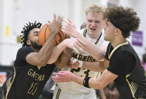Gateways Isaiah Allah (left) and Jax Vovaris fight for a rebound with Penn-Traffords Ethan McDonald on Tuesday. (Chaz Palla | TribLive)