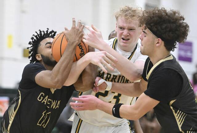 Gateways Isaiah Allah (left) and Jax Vovaris fight for a rebound with Penn-Traffords Ethan McDonald on Tuesday. (Chaz Palla | TribLive)