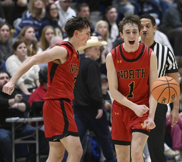 North Catholics Jude Rottmann (1) celebrates with Jason Fredericks after defeating Knoch on Tuesday, Feb. 3, 2026, in Saxonburg. (Christopher Horner | TribLive)