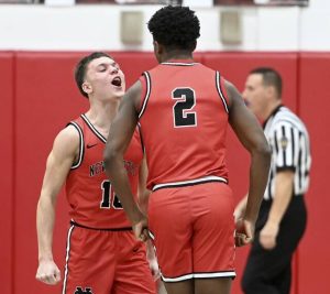 New Castles Chase Lemmon celebrates with Damian Harrison after Harrison hit a 3-pointer during the fourth quarter Jan. 9 at Fox Chapel. (Christopher Horner | TribLive)