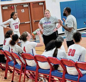 Jeannette coaches Jenna Lusby (center) and Arnold Lusby (right) talk to their players during a game earlier this season. (Bill Beckner Jr. | TribLive)