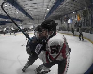 Seneca Valleys Cooper Hoehn checks Fox Chapels Gavin Forbes into the boards Nov. 17, 2025, at Baierl Ice Center. (Christopher Horner | TribLive)