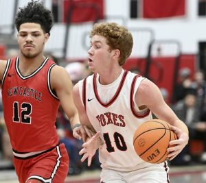 Fox Chapels Anderson Dockey drives past New Castles Kai Cox on Jan. 9. (Christopher Horner | TribLive)