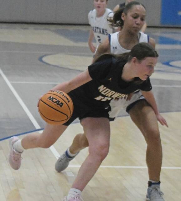 Norwins Lenyn Brozeski (10) drives around Hempfields Ava Shipman in the first half Thursday. (Paul Schofield | TribLine)
