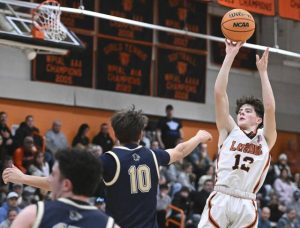 Latrobes Sawyer Butina hits a shot over Franklin Regionals Colin Holt on Jan. 30. (Chaz Palla | TribLive)