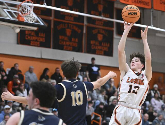 Latrobes Sawyer Butina hits a shot over Franklin Regionals Colin Holt on Jan. 30. (Chaz Palla | TribLive)