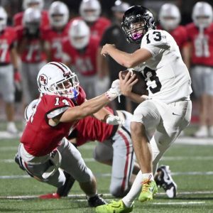 Peters Townships Reston Lehman pressures Upper St. Clair quarterback Ethan Hellmann during the fourth quarter on Friday, Sept. 26, 2025, at Peters. (Christopher Horner | TribLive)