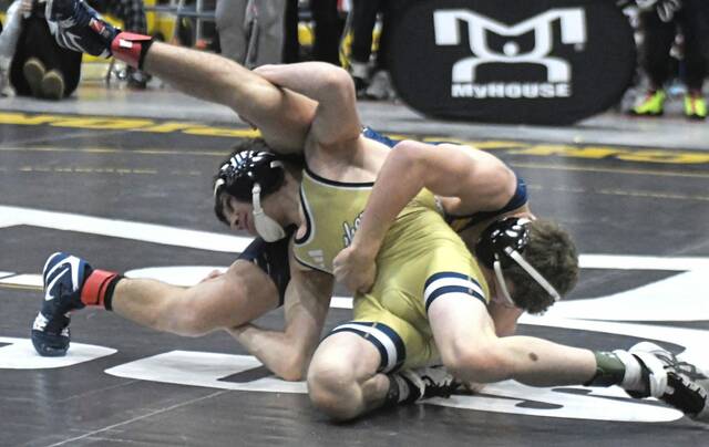 Franklin Regional Sal Colangelo takes down Norwins Dom Butera during a 107-pound match in the PIAA 3A championships on Saturday. (Paul Schofield | TribLive)