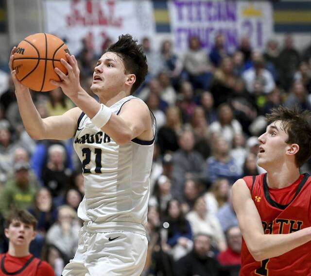 Knochs Teegan Finucan scores past North Catholics Jude Rottmann on Feb. 3. (Christopher Horner | TribLive)