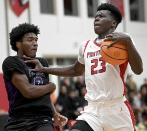 Sewickley Academys Mamadou Kane drives past Obama Academys Sheikh Long on Jan. 28. (Christopher Horner | TribLive)
