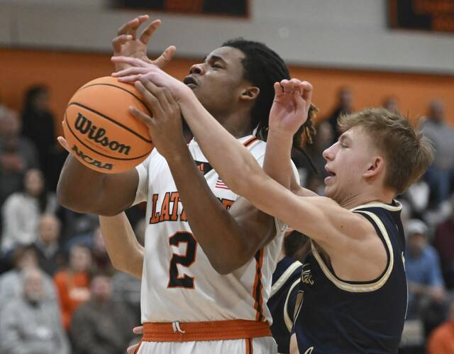 Franklin Regionals Logan Walter fouls Latrobes Rob Young on Jan. 30. (Chaz Palla | TribLive)