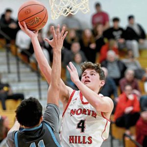 North Hills Jackson Long scores against Seneca Valleys Tyler Pepin on Jan. 24, 2025. (Christopher Horner | TribLive)