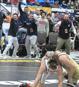 Franklin Regional gets excited after Max Firestine turned a reversal to defeat Norwins Nathan Klingensmith at 145 pounds in the PIAA championships. (Paul Schofield | TribLive)