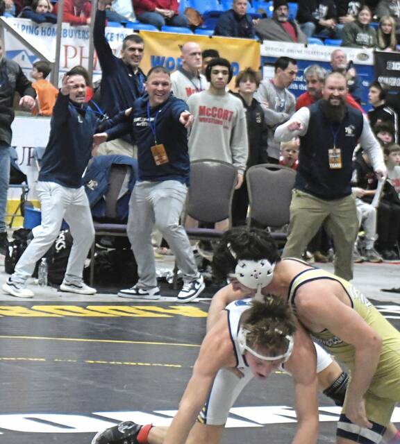 Franklin Regional gets excited after Max Firestine turned a reversal to defeat Norwins Nathan Klingensmith at 145 pounds in the PIAA championships. (Paul Schofield | TribLive)