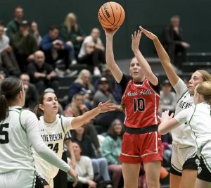North Hills Zoe Devlin scores between Pine-Richland defenders Jan. 29. (Christopher Horner | TribLive)