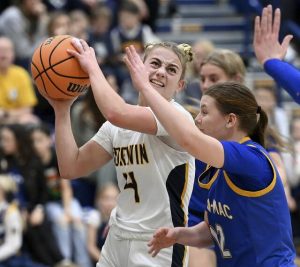 Norwins Nia OBarto drives to the basket against Canon-McMillans Isabella Urso on Feb. 2. (Christopher Horner | TribLive)