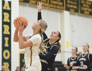 Penn-Traffords Raya Johnson scores and is fouled as Franklin Regionals Katherine Yaniga defends during a WPIAL Class 5A first-round game Friday. (Chaz Palla | TribLive)