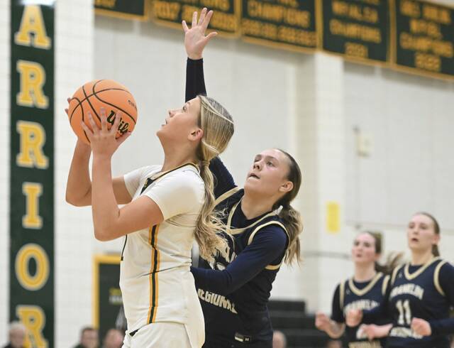 Penn-Traffords Raya Johnson scores and is fouled as Franklin Regionals Katherine Yaniga defends during a WPIAL Class 5A first-round game Friday. (Chaz Palla | TribLive)
