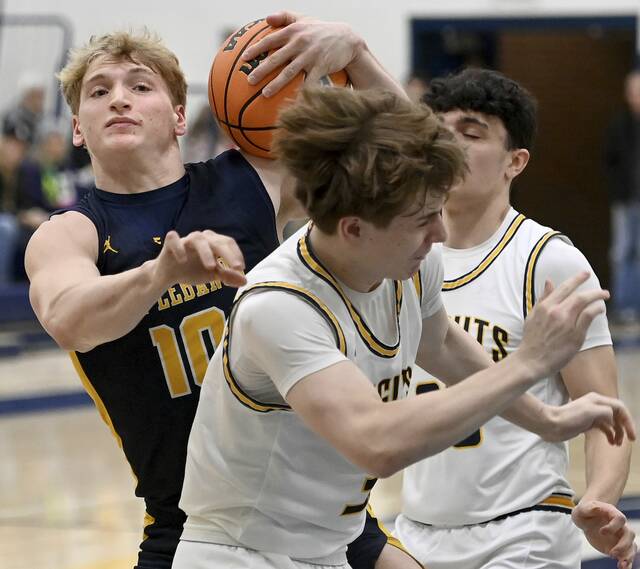 Mt. Lebanon’s Patrick Smith grabs a rebound between Norwin’s King Carver and Nate Kuch during their game on Tuesday, Jan. 27, 2026, at Norwin. (Christopher Horner | TribLive)
